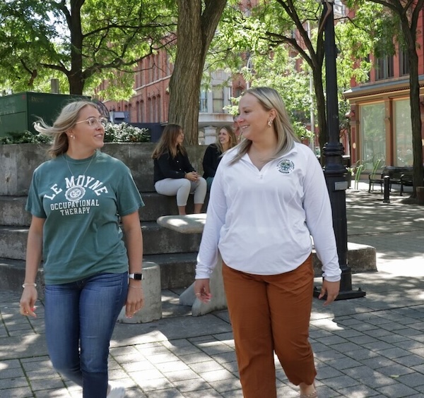 Two students walking near campus