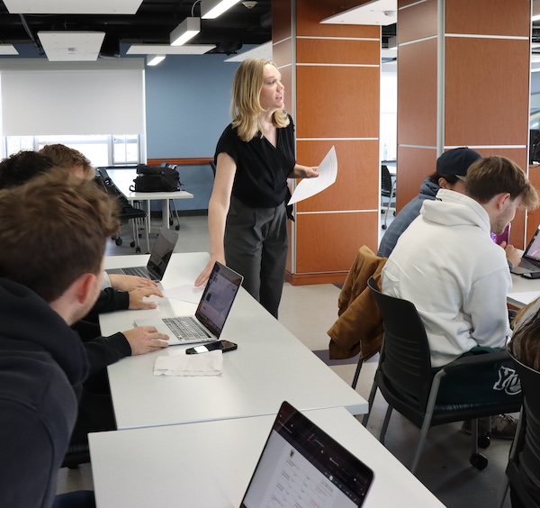 Students in class listening to a professor.